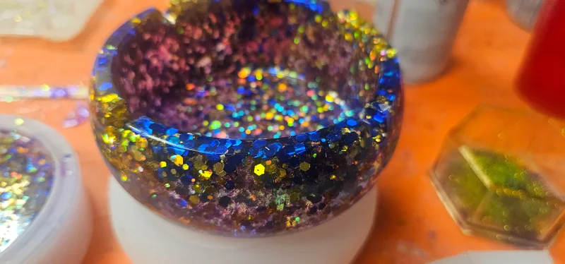 Glitter suspended in resin