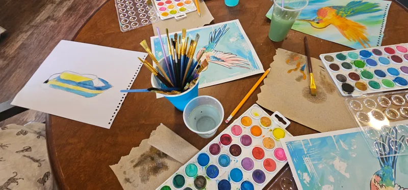 A watercolour palette and brushes