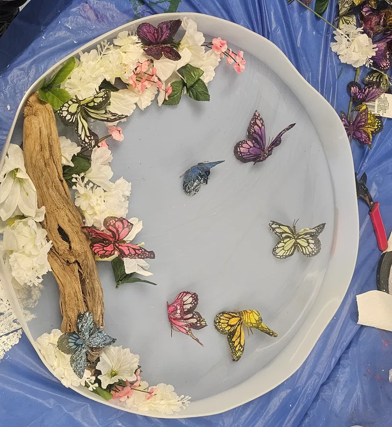 Cast flowers and butterflies laid out to dry