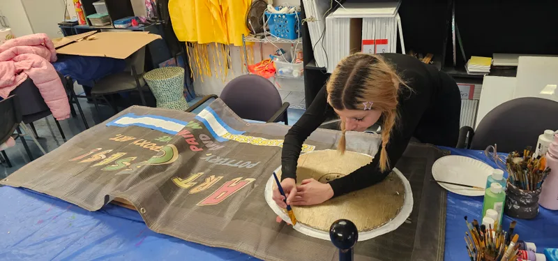 Hands shaping clay at the studio table