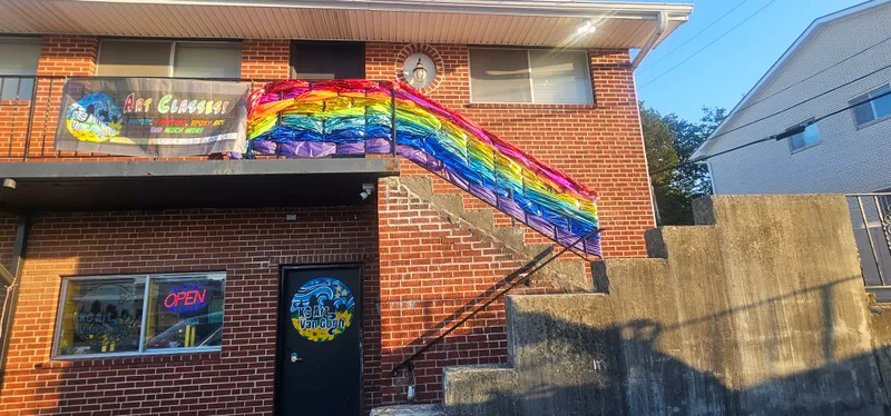 The studio on 63rd Street in historic downtown Raytown, with a rainbow mural on the brick